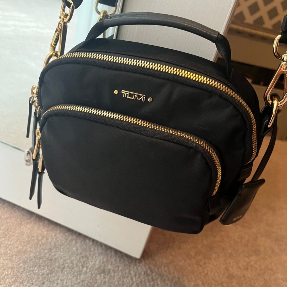 Tumi Black Crossbody Camera Bag with Gold Hardware Accents